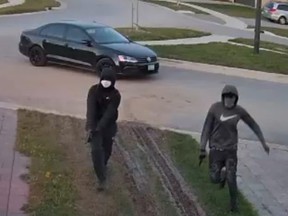 London police released this image of two suspects in the Sept. 10, 2021, shooting death of London nurse Lynda Marques at her upscale northwest London house. A police task force to investigate her death cost $560,000. Two arrests have been made, but the two men in the video remain at large. (Supplied)