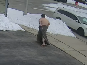 A naked man wrapped in a blanket is seen in surveillance footage captured during post-crash chaos on Saturday, Feb. 26, 2022 in Cambridge. The four-minute video was posted to YouTube.