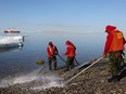 Canadian Rangers participate in the cleanup of a mock oil spill in Resolute, Nunavut in this file photo. They are fine civil defence volunteers but no substitute for the military.