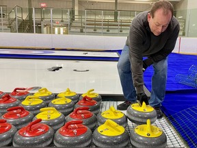 U21 curling tournament volunteer Jeff Gale helps get the rocks ready for the competition, which kicks off Saturday morning at Stratford's Rotary Complex.