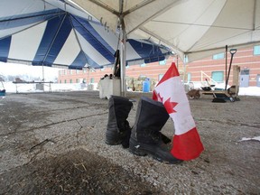 A pair of boots and a Canadian flag left behind for clean-up after the Ottawa protesters cleared out. REUTERS/Lars Hagberg