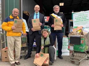 The annual spring drive for the London Food Bank began Friday with the return of donation bags. Helping launch the drive were, from left, food bank co-director Glen Pearson, rTraction CEO David Billson, food bank co-director Jane Roy, and Knights of Columbus district deputy Gary Masters. (RANDY RICHMOND, The London Free Press)