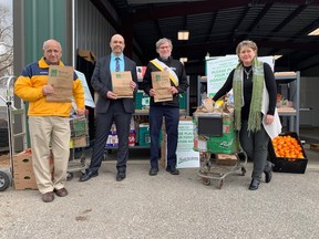 This month's annual London Food Bank spring drive will focus in part on refugees from Ukraine, organizers said at Friday's launch. Food bank co-directors Glen Pearson and Jane Roy flank rTraction chief David Billson and Knights of Columbus district deputy Gary Masters at the event. (Randy Richmond/The London Free Press)