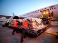 A Warsaw bound cargo plane is loaded with humanitarian aid, including medical supplies destined for Ukraine, at Pearson International Airport in Toronto, Canada, March 9, 2022.