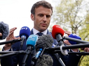 France's President and French liberal party La Republique en Marche (LREM) candidate to his succession Emmanuel Macron gestures as he addresses media during a one-day campaign visit in the Grand-Est region, in Mulhouse, eastern France, on April 12, 2022. - Emmanuel Macron and his rival French far-right party Rassemblement National (RN) presidential candidate have kicked off a final fortnight of bruising campaigning for the French presidency in a run-off that polls predict risks being tight. (Photo by Ludovic MARIN / AFP) (Photo by LUDOVIC MARIN/AFP via Getty Images)