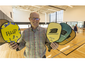 Chris Evans of Brickhouse Paddles shows off some of his hot-selling wares, pickleball paddles. He's photographed at the East Lions Community Centre in London. Mike Hensen/The London Free Press