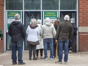 People line up for COVID-19 vaccinations at the mass vaccination clinic at the Western Fair District Agriplex in London on April 8, 2022. (Derek Ruttan/The London Free Press)