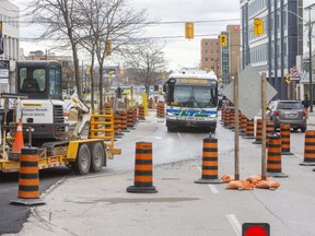 Downtown rapid transit system work will see some London Transit buses rerouted this spring and summer. Here, an LTC bus heads north in a southbound lane of Wellington Street, whose northbound lanes are closed at King Street by construction. (Derek Ruttan/The London Free Press)