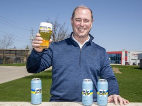 Brian Semkowski, president of Equals Brewing Company of London, has created a special can for his popular brew, Shake Lager. The new can features the slogan, Cheers To Ukraine, written in Ukrainian. Three hundred cases will be sold at the brewery's retail store at 695 Sovereign Rd. as part of a large fund-raising effort in support of Ukraine. (Derek Ruttan/The London Free Press)