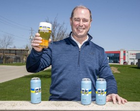 Brian Semkowski, president of Equals Brewing Company of London, has created a special can for his popular brew, Shake Lager. The new can features the slogan, Cheers To Ukraine, written in Ukrainian. Three hundred cases will be sold at the brewery's retail store at 695 Sovereign Rd. as part of a large fund-raising effort in support of Ukraine. (Derek Ruttan/The London Free Press)