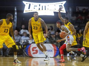 Jaylon Tate of the London Lighting guards Antonio Davis of Flint United while teammates Terry Thomas, Amir Williams and Mareik Isom play defense in their game against Flint United at Budweiser Gardens in London. Photograph taken on Sunday April 3, 2022. (Mike Hensen/The London Free Press)