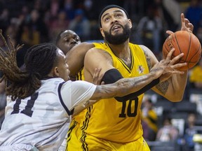 Cameron Forte of the London Lightning loses control of the ball going up as he is fouled by Jahlil Rawley of Flint United in a game Sunday, April 3, 2022, at Budweiser Gardens in London.
(Mike Hensen/The London Free Press)