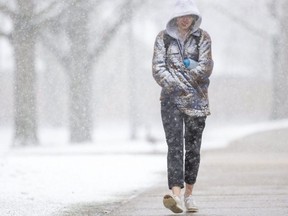 Sophie McKenzie, a third-year Western University student, walks through the heavy snowfall on campus in London. She laughed when asked about her views of the local weather. "Yeah, it’s great." Photograph taken on Monday April 18, 2022. (Mike Hensen/The London Free Press)