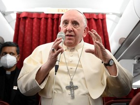 Pope Francis holds a news conference aboard the papal plane on his flight back after visiting Malta, April 3, 2022. (REUTERS)