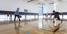 Humphrey Chung goes for a backhand during a doubles game of pickle ball with teammate Judy Rogers at the East Lions Community Centre in London. Mike Hensen/The London Free Press