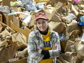 Jane Roy, co-executive director of the London Food Bank, stands near some of the 35,588 pounds (16,142 kgs) of food donated in the spring food drive that wrapped up Monday.  (Mike Hensen/The London Free Press)