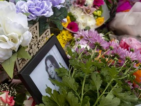 Flowers surround a photo of Western University student Maija Nenonen at her apartment building at 974 Western Rd. in London. Nenonen died Monday after she was hit by a vehicle in the parking lot of the building. (Mike Hensen/The London Free Press)