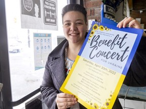 Christine Dawidenko holds a poster for an April 30 benefit concert for Ukraine she is asking London businesses to display. 
 (Mike Hensen/The London Free Press)