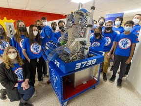 The Oakbotics FIRST (For Inspiration and Recognition of Science and Technology) robotics team with teacher coach Andrew Goddard, far right, have their robot named Mantis ready to go for an Ontario-wide competiton this week in Mississauga. The robot has to be able to move, pick up balls, throw them in a goal and climb. (Mike Hensen/The London Free Press)
