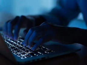 close up programmer man hand typing on keyboard laptop for register data system or access password at dark operation room , cyber security concept