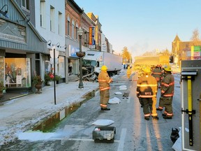 North Perth firefighters survey the  damage after a transport truck collided with a downtown Listowel building Jan. 21 in this photo posted to the OPP West Region Twitter account. A Mississauga trucker has been charged in the crash, Perth OPP said Friday. (Twitter photo)