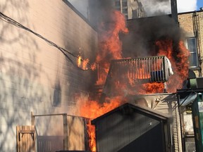 A wooden balcony and stairs at the back of the Ark Aid Street Mission at 696 Dundas St.  burn in a fire Tuesday night. London firefighters quickly extinguished the fast-moving fire that was driven by the wind, the London fire department said. (London fire department Twitter photo)
