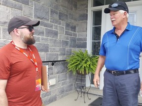 Chatham-Kent-Leamington NDP provincial candidate Brock McGregor, left, is shown with Blenheim resident Jim Ladouceur on Saturday, May 21, 2022. (Trevor Terfloth/Postmedia Network)