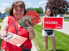 Mary Holmes, the LIberal Party candidate for Oxford, hands out pamphlets in Tavistock with volunteer Sandra Standish. (Chris Montanini/Postmedia News)