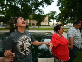 People pray at a vigil for the victims of a mass shooting at Robb Elementary School in Uvalde, Tex. (Billy Calzada/The San Antonio Express-News via AP)