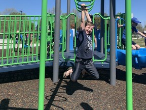 Rowan Gibson, 9, tries out the playground equipment Saturday at the opening of the East Lions Community Centre and Park. (Norman De Bono)