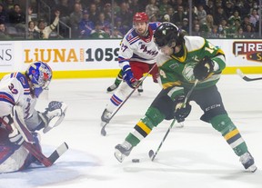 London Knights captain Luke Evangelista tries a trick to his legs but can't get past Kitchener Rangers keeper Jackson Parson during their game at Budweiser Gardens in London on Sunday May 1, 2022. Derek Ruttan/The London Free Press