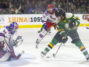 London Knight captain Like Evangelista tries a trick shot through his legs but can't fool Kitchener Rangers goalie Jackson Parson  during their game at Budweiser Gardens in London, Ont. on Sunday May 1, 2022. Derek Ruttan/The London Free Press/Postmedia Network