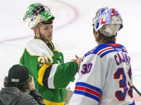 London Knights goalie Brett Brochu congratulates Kitchener Rangers goalie Pavel Cajan on his Game 7 overtime win at Budweiser Gardens in London on Wednesday, May 4, 2022. (Derek Ruttan/The London Free Press)