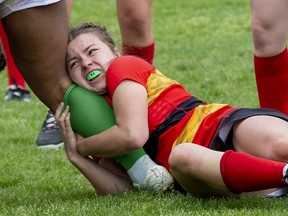 Natalie McIntosh of the Saunders Sabres tries to tackle Shyann Sutton of the Laurier Rams during their game at Saunders secondary school in London on Wednesday May 25, 2022. The Rams won the game 15-5. Derek Ruttan/The London Free Press