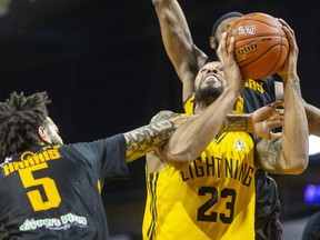 Amir Williams of the London Lightning is fouled by Jeremy Harris of the Sudbury Five in a game Thursday, May 12, 2022, at Budweiser Gardens in London. The Lightning won 125-115 and will face the Windsor Express in the first round of the playoffs. (Mike Hensen/The London Free Press)