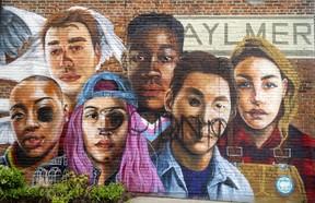 A multicultural mural painted by East Elgin secondary school students under the guidance of artist Meaghan Claire Kehoe in Aylmer in 2021 was vandalized Saturday with the word Sodom painted on it and some eyes blackened.  Photograph taken Monday, May 16, 2022. (Mike Hensen/The London Free Press)
