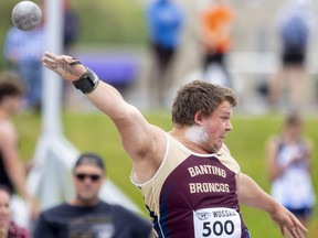 Liam Larson of Banting secondary school places second in senior boys shot-put with a throw of 13.39 metres during Day 2 of WOSSAA track and field at Western Alumni Stadium in London on May 20, 2022.  (Mike Hensen/The London Free Press)
