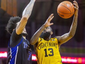 Terry Thomas of the London Lightning goes up for a shot against Tyran Walker of the KW Titans in the first game of the National Basketball League of Canada finals at Budweiser Gardens in London on May 27, 2022. (Mike Hensen/The London Free Press)