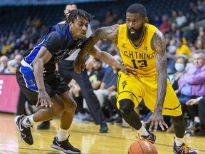 Terry Thomas of the London Lightning drives to the hoop around Juwan Miller of the KW Titans during the National Basketball League of Canada finals at Budweiser Gardens in London. Photograph taken on Friday May 27, 2022. Mike Hensen/The London Free Press/Postmedia Network