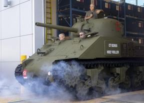 Three volunteers drive the Holy Roller tank out of a Fanshawe College garage and into its future as a war monument set to return to London’s Victoria Park. After an extensive rehabilitation, the Second World War tank is fixed up to last “for generations,” one volunteer said. Photograph taken on Monday May 30, 2022. (Mike Hensen/The London Free Press)