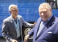 Jerry Pribil, the Progressive Conservative candidate in London North Centre, left, greets party leader Doug Ford as he gets off the campaign bus in London on Thursday, May 12, 2022. (Mike Hensen/The London Free Press)