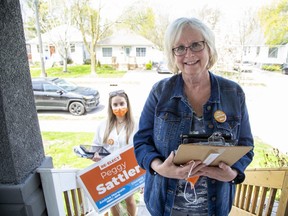 Clipboard in hand, campaign volunteer Ella Vitols at her side, London West NDP candidate Peggy Sattler approaches the door at a home in the Old South section of her riding as she canvasses households for the June 2 Ontario election. What voters see when candidates come door-knocking is only part of all-important campaign strategy and tactics. (Derek Ruttan/The London Free Press)