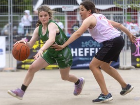 Addy Brosnan of the Three Pointers dribbles away from the defence of Quinn Pollock of the Splash Sisters during their U14 championship at the Got Game Sports tournament held in Victoria Park on Victoria Day weekend. Mike Hensen/The London Free Press