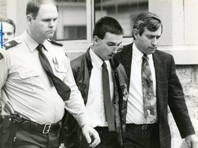 Jason Shawn Cofell, is seen in handcuffs outside the former Chatham courthouse, after he was charged with first-degree murder in the 1991 deaths of Jasen Pangburn and his grandparents Alfred and Virginia Critchley. (London Free Press files)