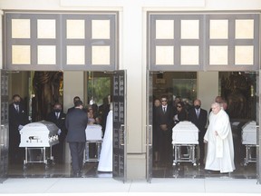 The caskets of Karolina Ciasullo and her three young daughters, six year-old Klara Ciasullo, four year-old Lilianna Ciasullo and one year-old Mila Ciasullo who were killed in a fatal vehicle crash, leave the funeral service in Brampton, Ont., on June 25, 2020.