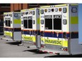 Ambulances sit outside of an emergency department.
