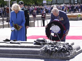 Prince Charles places a wreath as he and Camilla, Duchess of Cornwall, visit the National War Memorial in Ottawa, while on their Canadian Royal Tour, Wednesday May 18, 2022.
