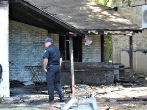 London fire department investigator Shawn Routenburg surveys the damage on Friday at 66 Blackfriars St., where a suspicious fire on Thursday caused $500,000 in damage, police said. (Dale Carruthers/The London Free Press)