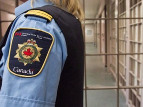 A correctional officer looks on at the Collins Bay Institution in Kingston, Ont., on Tuesday, May 10, 2016, during a tour of the facility.