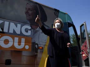 Ontario NDP Leader Andrea Horwath gives a thumbs up before returning to her bus after a campaign event at a park in Ottawa, on Tuesday, May 31, 2022.